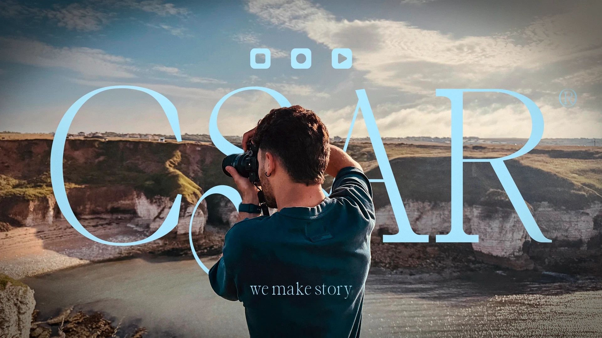 Cesar photographing a coastal landscape, with CSAR visual identity