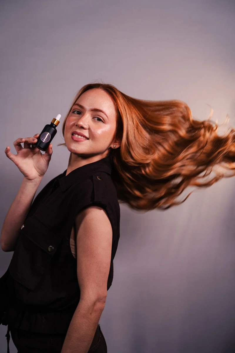 Model presenting the hair tonic product