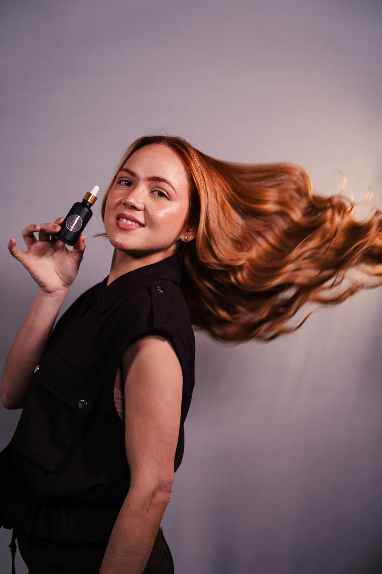 Model presenting the hair tonic product
