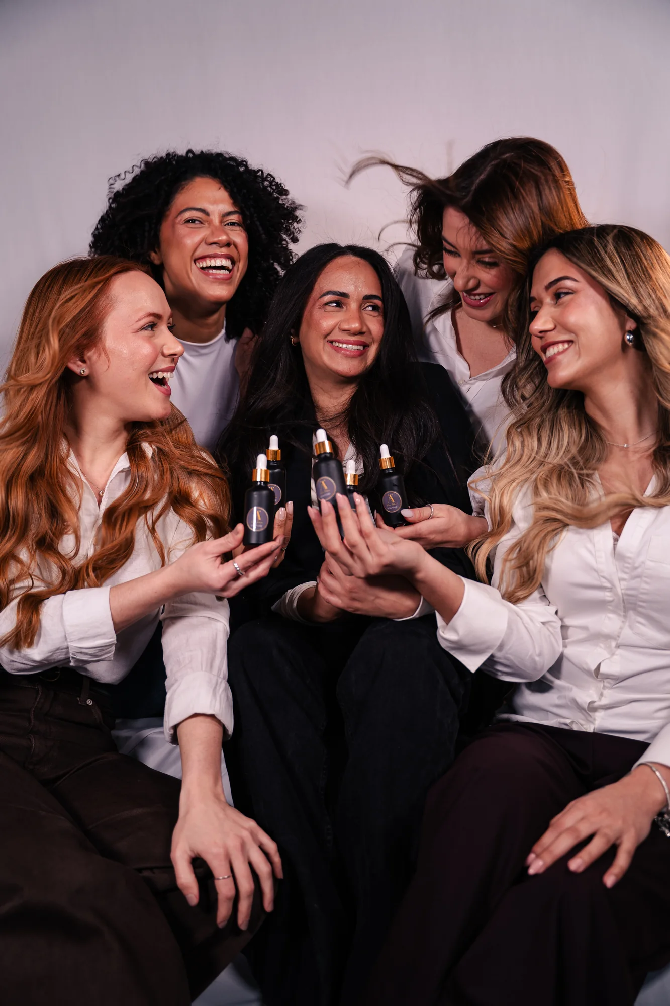 Campaign group portrait with hair tonic bottles