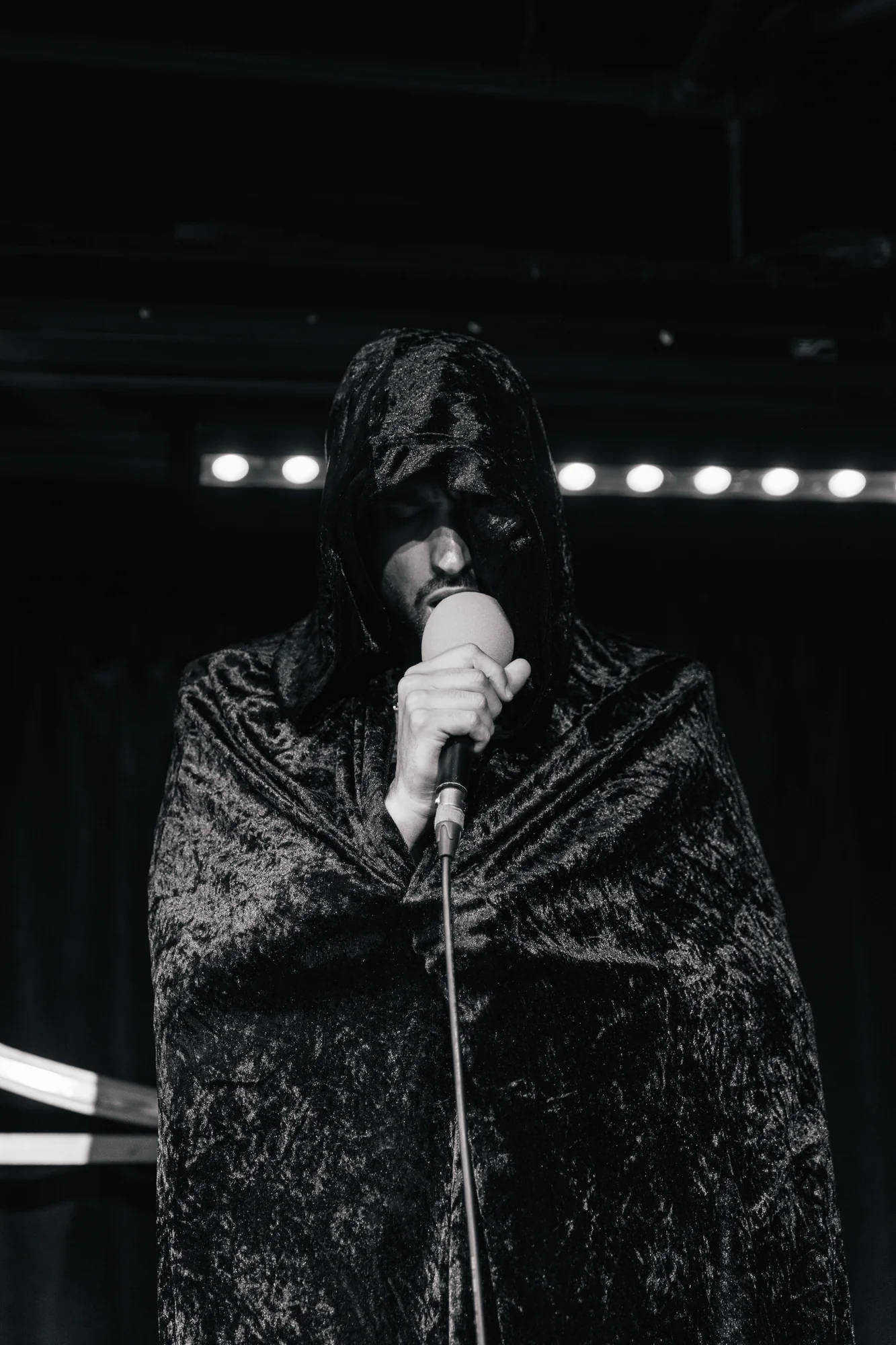 Black-and-white portrait of a singer on stage