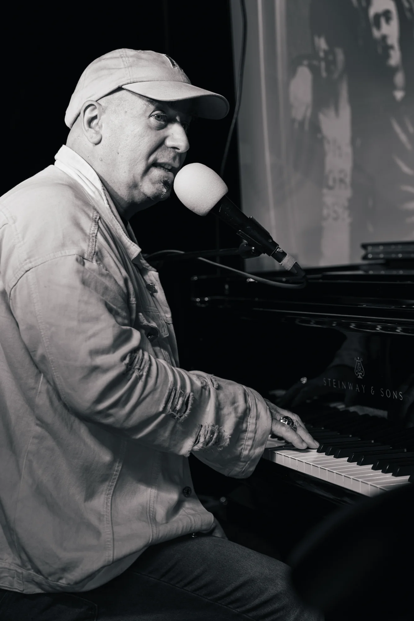 Pianist performing in a black-and-white stage portrait