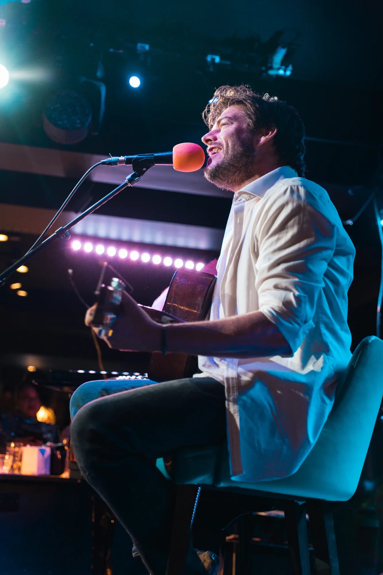Live performance photographed from behind a musician